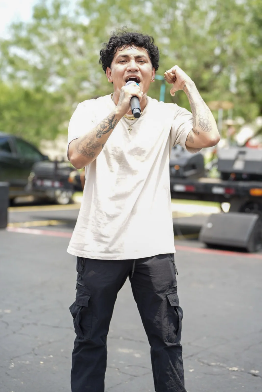A performer leads worship on the outdoor stage at Holy City Market.